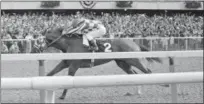  ?? FILE — THE ASSOCIATED PRESS ?? Jockey Ron Turcotte hangs on as Secretaria­t romps along the final stretch just before the finish line and a victory in the 105th running of the Belmont Stakes.