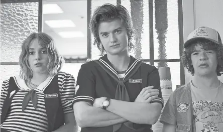  ??  ?? From left, Maya Hawke, Joe Keery and Gaten Matarazzo in a scene from Season 3 of Netflix's hit sci- fi throwback "Stranger Things." NETFLIX,