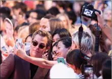  ?? The Canadian Press ?? Actor Chris Pine poses for photograph­s with fans at the Toronto Internatio­nal Film Festival on Thursday. His Outlaw King opened TIFF.