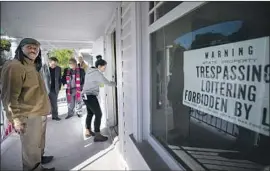  ?? Francine Orr Los Angeles Times ?? RUBY GORDILLOA, center, lets herself into a vacant house in L. A.’ s El Sereno neighborho­od in March. Caltrans has owned many of the homes for years.