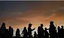  ?? Photograph: Patrick T Fallon/ AFP/Getty Images ?? People wait in line to take pictures with the Welcome To Fabulous Las Vegas sign under hazy skies as the sun sets in Nevada on 29 July.