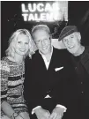  ??  ?? Kendall Cross and Matt Frewer fl ank Richard Lucas to celebrate his acquiring Muse Entertainm­ent and JR Talent.