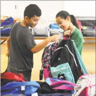  ?? Tyler Sizemore / Hearst Connecticu­t Media ?? Rising fourth-grader Diego Perez and rising sixth-grader Eva Perez, both of Greenwich, choose new backpacks at the annual backpack giveaway at the Boys &amp; Girls Club in Greenwich on Monday. With donations from First United Methodist Church, Diamond Hill United Methodist Church and Little Pub, the giveaway provided backpacks and school supplies for 300 elementary- through high school-aged students enrolled at the Boys &amp; Girls Club of Greenwich. More than half of the members of Boys &amp; Girls Club qualified for the needs-based giveaway. The giveaway continues Tuesday from 8 a.m. to 4 p.m.