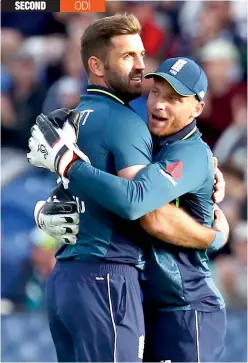  ??  ?? England’s Liam Plunkett (left) and Jos Buttler celebrate the dismissal of Australia’s Shaun Marsh in their second ODI at Cardiff on Saturday. England won by 38 runs. — AFP