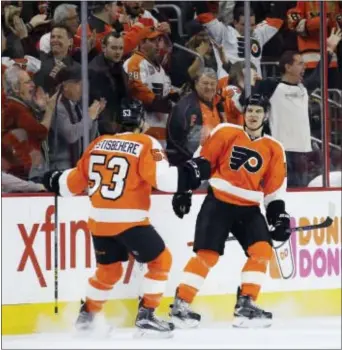  ?? MATT SLOCUM — THE ASSOCIATED PRESS ?? Brayden Schenn, right, is greeted by teammate Shayne Gostisbehe­re after Schenn converted a breakaway into the game’s first goal in the first period of the Flyers’ 4-3 win over Montreal Tuesday night. Schenn later added two assists.