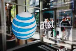  ?? —AP ?? PHILADELPH­IA: In this Oct. 17, 2012, photo, an AT&T logo is displayed on an AT&T Wireless retail store front.