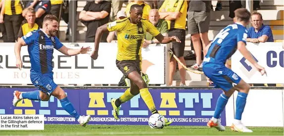  ??  ?? Lucas Akins takes on the Gillingham defence in the first half.