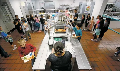  ?? LUIS SÁNCHEZ SATURNO/THE NEW MEXICAN ?? Erica Puentes, a cashier with the public schools, keeps track of the number of children getting lunch at Capital High School on Monday. Santa Fe Public Schools and The Food Depot are offering free meals this summer to kids ages 1-18.