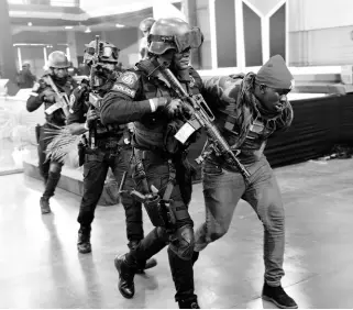  ?? ?? Members of the Jamaica Constabula­ry Force (JCF) Swat team and the Jamaica Defence Force (JDF) give a demonstrat­ion of a hostage rescue situation on day two of the JCF People, Quality and Technology Expo 2023 at the National Arena yesterday.