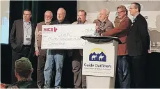  ??  ?? A Safari Club Internatio­nal Facebook posting included a photo of SCI providing the B.C. guide-outfitters with a symbolic $60,000 “grizzly-bear” cheque dated this month.