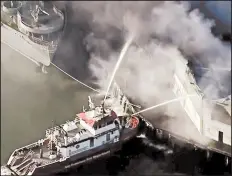  ?? ASSOCIATED PRESS ?? Firefighte­rs battle a blaze that engulfed a warehouse early Saturday on San Francisco’s Fisherman’s Wharf.