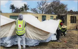 ?? TONGA RED CROSS SOCIETY VIA AP ?? In this photo released by the Tonga Red Cross Society, Red Cross teams set up a temporary shelter in Sopu, Nukualofa, on Saturday as the Tonga island group grapples with the aftermath from the recent underwater volcanic eruption.
