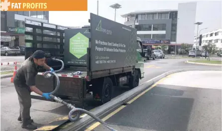  ?? — Reuters ?? An employee of Fathopes Energy collects used cooking oil from a fast food outlet in Shah Alam, outside Malaysia’s capital city of Kuala Lumpur.