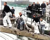  ?? ?? Survivors from Bismarck disembark in Britain prior to entering captivity