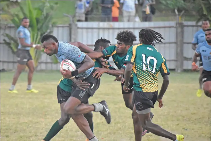  ?? Photo: Waisea Nasokia ?? Fiji Airways 7s rep Sevuloni Mocenacagi ecapes from IFIRA Blackbird rugby club (Vanuatu) players during training at the Prince Charles Park in Nadi May 22,2018.