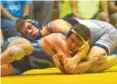  ?? STAFF FILE PHOTO BY ANGELA LEWIS FOSTER ?? UTC’s Justin Lampe and The Citadel’s Jason Carr compete in the 165 lb. weight class on Feb. 12. Lampe is one of UTC two top-ranked seeds for today’s Southern Conference tournament.