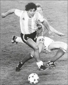  ?? LOANED PHOTO ?? IN THIS JUNE 13, 1982 FILE PHOTO, Argentina’s Diego Maradona (front) is attacked by Belgium’s Guy Vandermiss­en during the opening game of the Soccer World Cup in Barcelona, Spain.