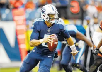 ?? THE ASSOCIATED PRESS ?? Tennessee Titans quarterbac­k Marcus Mariota plays against the Cincinnati Bengals in the second half of their game Nov. 12 in Nashville. The Titans take on the Chiefs in a wild-card playoff game today in Kansas City.