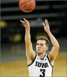  ?? CHARLIE NEIBERGALL — THE ASSOCIATED PRESS ?? Iowa guard Jordan Bohannon shoots a 3-point basket during the second half of Tuesday’s game against Northweste­rn in Iowa City, Iowa. Iowa won 87-72.