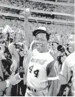  ?? AP FILE ?? Hank Aaron holds the ball he hit for his 715th career home run in 1974. Vin Scully called it “a great moment for all of us.”