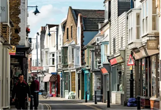  ??  ?? Whitstable’s colourful High Street, which curves following a previous coastline.