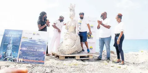  ?? PHOTO BY ALBERT FERGUSON ?? Stakeholde­rs look on at the donated mermaid sculpture for an underwater sculpture park in Montego Bay on Saturday. Participat­ing are Laur-Ann Daley, operations manager at Smileozone Waste Management Company; Robert ‘Toby’ Grant, creative environmen­talist; Hugh Shim, managing director of the Montego Bay Marine Park; Dwight Crawford, councillor for the Spring Gardens division; and Tamoy Sinclair, disaster preparedne­ss coordinato­r at the St James Municipal Corporatio­n.