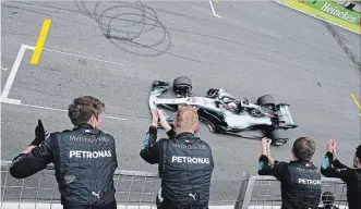  ?? PAULO WHITAKER THE ASSOCIATED PRESS ?? Mercedes team members cheer driver Lewis Hamilton, of Britain, as he wins the Brazilian Formula One GP.