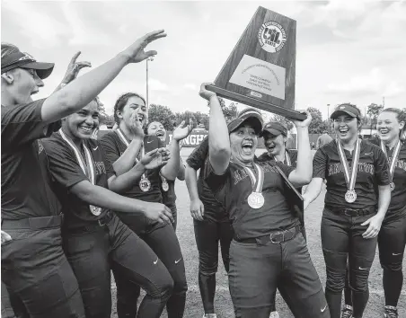  ?? Stephen Spillman / Contributo­r ?? Angleton pitcher Aaliyah Garcia gives the Class 5A championsh­ip trophy an enthusiast­ic lift after the Lady Cats’ victory Saturday at McCombs Field. Garcia also collected game MVP honors.