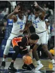  ?? JOHN LOCHER-THE ASSOCIATED PRESS ?? UCLA’S Brandon Williams (5) and Dylan Andrews (2) guard Oregon State’s Jordan Pope on Wednesday.