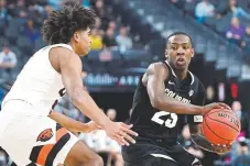  ?? Ethan Miller, Getty Images ?? Colorado’s McKinley Wright passes against Oregon State’s Ethan Thompson during Thursday’s quarterfin­al game in the Pac12 basketball tournament in Las Vegas. The Buffs defeated the Beavers 7358.