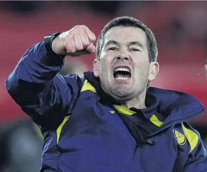  ?? PHOTO: REUTERS ?? Take that . . . Burton Albion manager Nigel Clough celebrates after his side won 10 at Middlesbro­ugh in their English League Cup quarterfin­al yesterday.