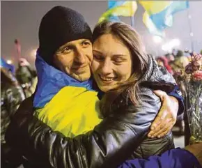  ?? REUTERS PIC ?? A recently exchanged prisoner of war from the Ukrainian armed forces is embraced on his arrival at Boryspil Internatio­nal airport outside Kiev, Ukraine, yesterday.