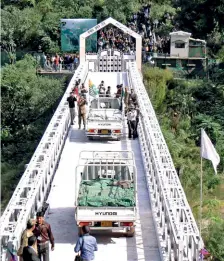  ??  ?? PEACE TIME Vehicles carrying fruits and vegetables from PoK entering the Indian side