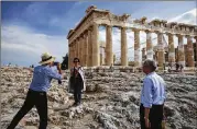  ?? YORGOS KARAHALIS / BLOOMBERG 2017 ?? Chinese tourists take photos in front of the Parthenon last May during a visit to the Acropolis in Athens. Greece is emerging from years of economic crisis with a healthy growth rate.