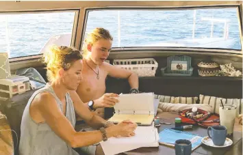  ??  ?? Krista Porter home schools her son Cole aboard their 42-foot Catamaran Saltair 3.