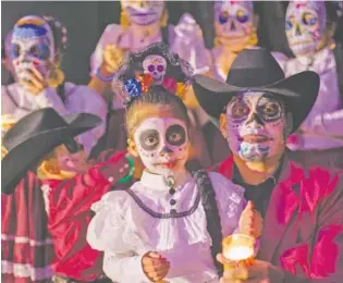  ?? CREATIVE ARTS GUILD CONTRIBUTE­D PHOTOS ?? White skull faces and traditiona­l clothing are the basics for a Dia de los Muertos costume, as shown by guests at a previous Day of the Dead party in Dalton, Georgia.