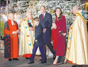  ?? James Manning The Associated Press ?? Britain’s Prince William and Kate, Princess of Wales, with children Prince George and Princess Charlotte at a holiday event on Thursday.