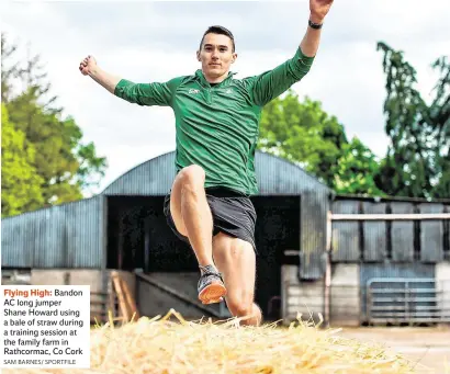  ??  ?? Flying High: Bandon AC long jumper Shane Howard using a bale of straw during a training session at the family farm in Rathcormac, Co Cork