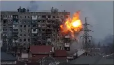  ?? EVGENIY MALOLETKA — THE ASSOCIATED PRESS FILE ?? An explosion erupts from an apartment building after a Russian army tank fired on it in Mariupol, Ukraine, March 11, 2022. The image is part of the documentar­y “20Days in Mariupol.”