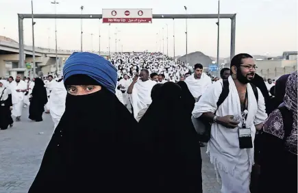  ?? NARIMAN EL-MOFTY/ASSOCIATED PRESS; BELOW, DIAA HADID/THE NEW YORK TIMES ?? Pilgrims arriving in the tent city of Mina, where nearly two million pilgrims slept for three days as part of their hajj rites; and, left, the Times correspond­ent Diaa Hadid.