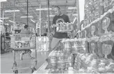  ??  ?? Yigo resident Jesse Cruz loads bottles of drinking water into his cart at a Home Depot in Tamuning, Guam, on Saturday. He said the water was for normal use in his fiveperson household.