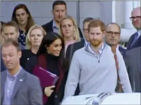  ?? AUSTRALIAN POOL VIA AP ?? Britain’s Prince Harry, center right, and his wife Meghan, center left, Duke and Duchess of Sussex, approach a car at an airport in Sydney, Monday, Oct. 15, 2018. Prince Harry and his wife Meghan arrived in Sydney on Monday, a day before they officially start a 16-day tour of Australia and the South Pacific.