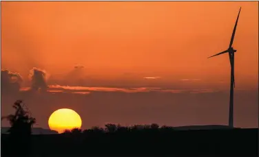  ?? (AP/Martin Meissner) ?? A wind turbine is seen Monday at sunset in Gelsenkirc­hen.