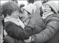  ?? AP/LEE JIN-WOOK ?? Relatives of victims of the 2014 Sewol ferry disaster comfort one another Saturday as they watch the sunken ship being pulled from the water off Jindo, South Korea.