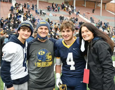  ?? PAUL DICICCO — FOR THE NEWS-HERALD ?? Kirtland coach Tiger LaVerde with members of his family after the state-championsh­ip win over Ironton, including son Jake (left), son Phillip (No. 4) and wife Mary. Not shown is daughter Leah.