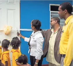  ?? CONTRIBUTE­D PHOTOS ?? From left: Students look on as Sharon Williams, Kiwanis Lt Gov 2017-2018, cuts the ribbon to declare the new kitchen open. She is supported by Leighton James, president of Kiwanis Club of Stony Hill, and George Lynch, pastor of the Wesleyan Holiness Church, Golden Spring, St Andrew.