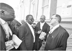  ??  ?? Lawyers representi­ng Chamisa arrive at court to challenge Mnangagwa’s election victory in Harare, Zimbabwe. — Reuters photo