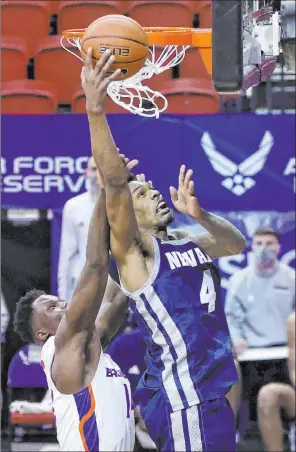  ?? Isaac Brekken The Associated Press ?? UNR guard Desmond Cambridge Jr. shoots against Boise State guard Emmanuel Akot in the second half of the Wolf Pack’s 89-82 win Thursday at the Thomas & Mack Center.