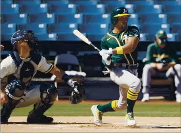  ?? STEPH CHAMBERS — GETTY IMAGES ?? The A’s Tony Kemp singles against the Milwaukee Brewers to lead off Tuesday’s spring training game at American Family Fields of Phoenix. Kemp went on to steal second and score in Oakland’s 2-1 victory.