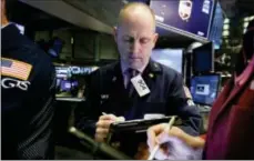  ?? RICHARD DREW — THE ASSOCIATED PRESS FILE ?? Trader Michael Urkonis works on the floor of the New York Stock Exchange.